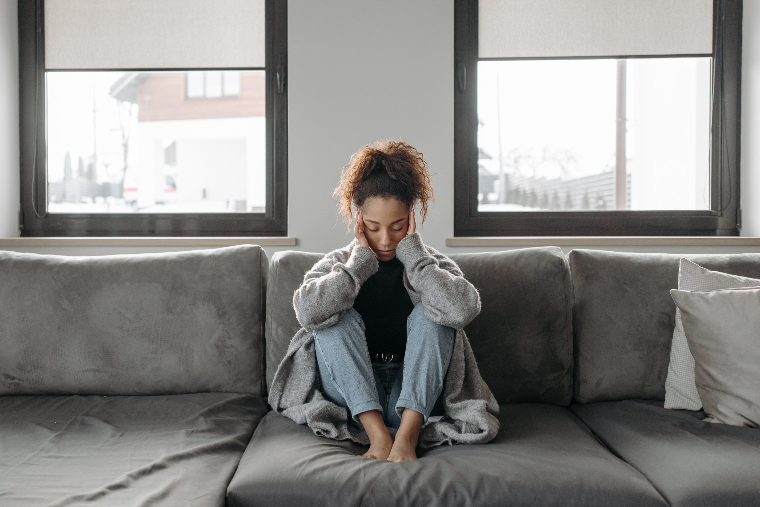 person sitting on couch under stress